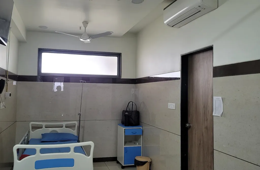Inpatient room with hospital bed and bedside unit at Divine Women's Hospital